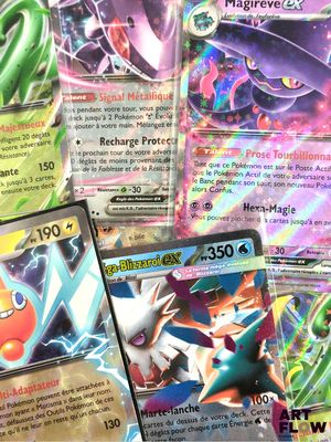 several pokemon cards sitting on top of each other on a table