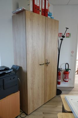 a desk with a printer and a cabinet in the room