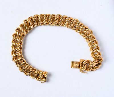 une image d'un bracelet en or sur une surface blanche