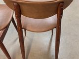 two chairs and a table in a room with a lot of furniture
