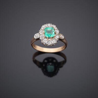 an emerald and diamond cluster ring