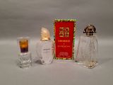 a bottle of perfume next to a shot glass and a box of perfume