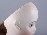 a close up of a doll ' s head with a hair band