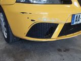 a yellow car that is parked in a garage