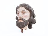 a statue of a man with a beard on a stick