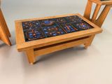 a small table with two chairs and a table with a tile on it
