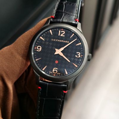 a close up of a person ' s hand holding a watch
