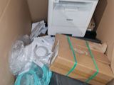 a cardboard box with a printer and other electronics in it