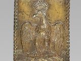 an image of a gold plate with a bird on it