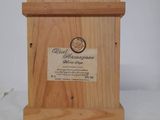 a small wooden box with a plaque on it