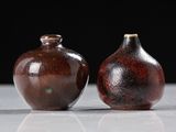 two vases that are sitting on a table