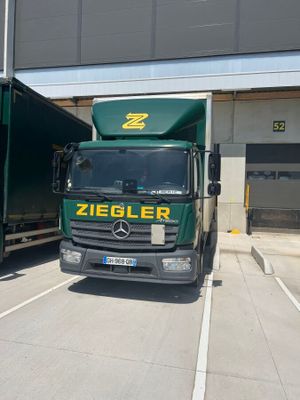 two trucks that are parked next to each other on the street