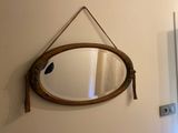 a mirror hanging on the wall in a bathroom