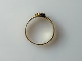 a close up of a gold ring with a black stone on it