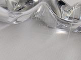 a glass sculpture of a woman laying down on a bed