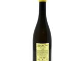 a bottle of wine sitting on top of a white table