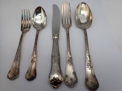 four forks and two spoons and a knife on a table