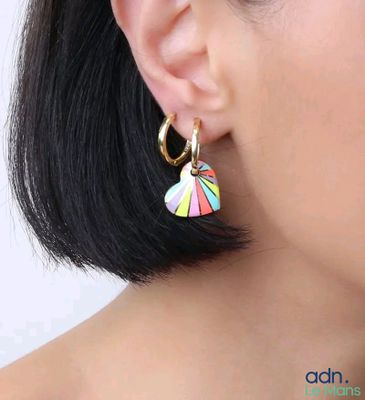 un gros plan sur une femme portant une paire de boucles d'oreilles