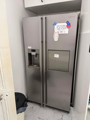 a silver refrigerator in the corner of a kitchen
