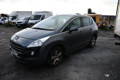 a black car parked in a lot with other cars