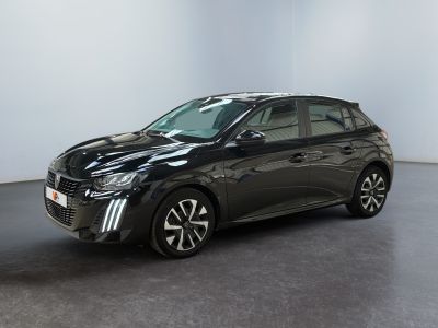 La Toyota Corolla noire est garée dans une grande pièce.