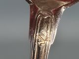 a silver spoon with a star on it sitting on top of a table