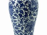 a blue and white vase sitting on a white surface