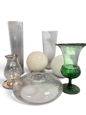 many different colored glass vases and vases on the table