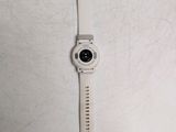 a white watch with a black face on a white surface