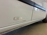 a white car with a sticker on the side of it