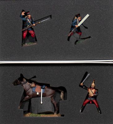 three figurines of a man on a horse and a man on a horse with a sword