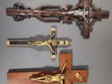 two wooden crucifixs and a wooden cross on a table