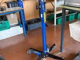 an image of a mechanic ' s shop with tools on the floor