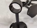 a pair of black ear plugs on top of a bed