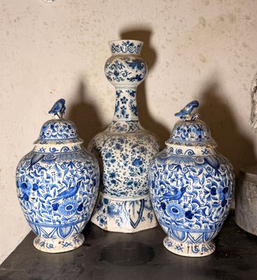 trois vases bleus et blancs posés sur une table