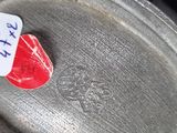 a red heart on a metal pan with a sticker on it