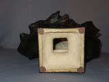 a small square shaped object with a hole in it