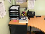 a desk with a computer, printer, phone, and other office supplies on it