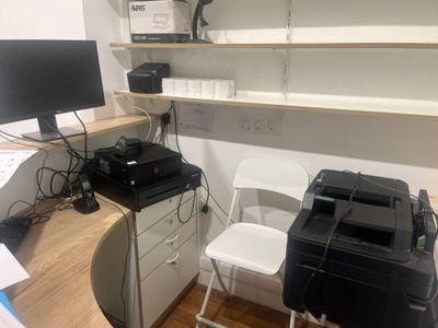 a desk with a printer and a printer on it
