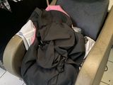 a chair with a pile of clothes on it next to a sink