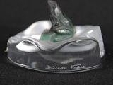 a glass figurine of a fish on a wave