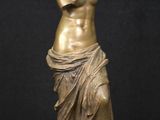 bronze statue of a woman holding a vase
