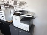 a picture of a printer and printer cabinet in a room