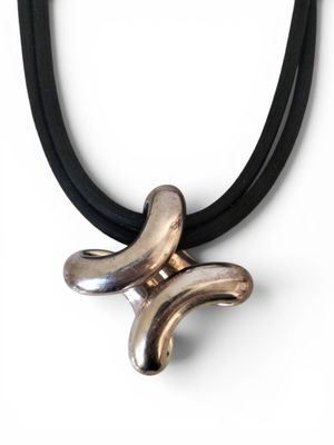 silver and black leather necklace with a silver and black pendant on a black cord