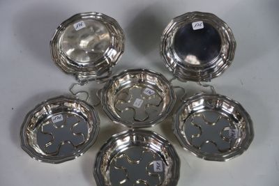 six silverplated dishes on a white surface