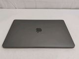 an apple macbook pro laptop sitting on top of a white surface