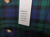 a blue and green plaid shirt with a tag on it