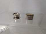 two silver rings on a clear shelf in a room