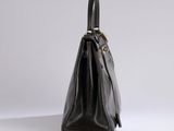 a black leather handbag on a white background