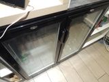 a refrigerator with two glass doors on the side of it